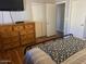 Bedroom view featuring wood floors and ample storage space in a wooden dresser at 2649 N 85Th Ave, Phoenix, AZ 85037