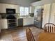 Kitchen features white cabinets, stainless steel appliances, and a breakfast nook at 2649 N 85Th Ave, Phoenix, AZ 85037