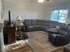Spacious living room with a large sectional sofa, comfortable seating, and a window for natural light at 2649 N 85Th Ave, Phoenix, AZ 85037