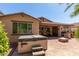 Well-maintained backyard with a hot tub, covered barbecue, and comfortable seating area at 2680 E Lodgepole Dr, Gilbert, AZ 85298