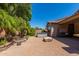 Backyard with a hot tub, waterfall feature, covered grill and pavers, and seating area at 2680 E Lodgepole Dr, Gilbert, AZ 85298