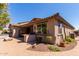 Well-manicured backyard with an outdoor grill, cactus plants and a covered seating area at 2680 E Lodgepole Dr, Gilbert, AZ 85298
