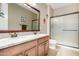 Well-lit bathroom featuring a double vanity, ample counter space, and a glass-enclosed shower at 2680 E Lodgepole Dr, Gilbert, AZ 85298