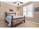 Cozy bedroom featuring carpeted floors, a ceiling fan, and a full-size bed with a wooden frame at 2680 E Lodgepole Dr, Gilbert, AZ 85298