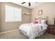 Bright bedroom with a ceiling fan, carpeted floors, and traditional furnishings at 2680 E Lodgepole Dr, Gilbert, AZ 85298