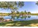 Picturesque lake reflecting the clear blue sky and surrounding trees, enhancing the community's natural beauty at 2680 E Lodgepole Dr, Gilbert, AZ 85298