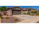 Home featuring a two-car garage, desert landscaping, and brick-paver accents at 2680 E Lodgepole Dr, Gilbert, AZ 85298