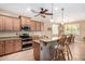 Kitchen area with stainless steel appliances, counter seating, and ample cabinet space at 2680 E Lodgepole Dr, Gilbert, AZ 85298