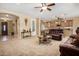 Open-concept living room with carpet flooring and an archway leading to the kitchen at 2680 E Lodgepole Dr, Gilbert, AZ 85298