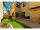 Spacious backyard boasting artificial turf, a brick patio, and a tall fence for privacy at 3485 S Seneca Way, Gilbert, AZ 85297