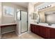 Bathroom features a tiled floor, double sink vanity, and glass enclosed shower at 3485 S Seneca Way, Gilbert, AZ 85297