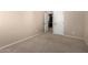 This carpeted bedroom features a view of a small closet and neutral colored walls at 3485 S Seneca Way, Gilbert, AZ 85297