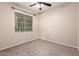 Bedroom features carpet, neutral walls, and a ceiling fan at 3485 S Seneca Way, Gilbert, AZ 85297