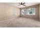 Bright bedroom with carpet, ceiling fan, and large windows to allow ample natural light at 3485 S Seneca Way, Gilbert, AZ 85297