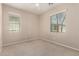 Light filled bedroom with neutral carpet, window coverings, and light colored walls at 3485 S Seneca Way, Gilbert, AZ 85297
