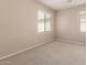Neutral carpeted bedroom offering bright light with two windows with wood blinds at 3485 S Seneca Way, Gilbert, AZ 85297