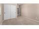 Bedroom featuring neutral walls and carpet with a closet and view to the hall at 3485 S Seneca Way, Gilbert, AZ 85297