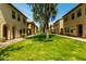 View of a green space and sidewalks in a desert community of townhomes at 3485 S Seneca Way, Gilbert, AZ 85297
