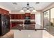 Kitchen featuring cherry cabinets, granite countertops, a tile backsplash, and island at 3485 S Seneca Way, Gilbert, AZ 85297