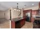 A cozy kitchen is enhanced with granite countertops, stainless appliances, and custom backsplash at 3485 S Seneca Way, Gilbert, AZ 85297