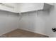 A walk-in closet boasts carpet flooring and ample space for organization at 3485 S Seneca Way, Gilbert, AZ 85297