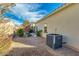 Low-maintenance backyard featuring gravel and tasteful plantings; property has an AC unit at 3566 S Colorado St, Chandler, AZ 85286