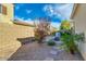 Backyard view with gravel landscaping, stone pavers, a built in bench, and a small fire pit at 3566 S Colorado St, Chandler, AZ 85286
