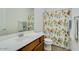 Bathroom featuring a single sink vanity with a white countertop and shower with a playful patterned curtain at 3566 S Colorado St, Chandler, AZ 85286