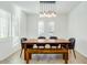 Bright dining room featuring shuttered windows, a wooden table, and modern lighting at 3566 S Colorado St, Chandler, AZ 85286
