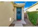 A welcoming blue front door adorned with a wreath, complemented by manicured greenery at 3566 S Colorado St, Chandler, AZ 85286