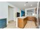 Open-concept kitchen features stainless appliances, an island, and wood flooring at 3566 S Colorado St, Chandler, AZ 85286