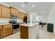 Kitchen with stainless steel oven and microwave, island, and a dining table nearby at 3566 S Colorado St, Chandler, AZ 85286