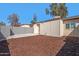 Large backyard features a spacious concrete patio and well maintained wood chip landscaping at 3646 N 69Th Ave # 55, Phoenix, AZ 85033