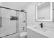 Modern bathroom features a walk-in shower, sleek vanity, and an illuminated mirror at 3646 N 69Th Ave # 55, Phoenix, AZ 85033