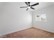 Cozy carpeted bedroom with natural light and a ceiling fan at 3646 N 69Th Ave # 55, Phoenix, AZ 85033