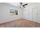 Carpeted bedroom with a large window and ceiling fan at 3646 N 69Th Ave # 55, Phoenix, AZ 85033