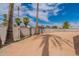 Vacant backyard with palm trees, block walls, and a clear blue sky at 3802 W Mission Ln, Phoenix, AZ 85051