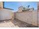 An enclosed backyard with a concrete block wall and access gate, providing a private outdoor space at 3802 W Mission Ln, Phoenix, AZ 85051