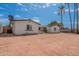 Vacant backyard with palm trees and the property's exterior at 3802 W Mission Ln, Phoenix, AZ 85051