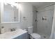 Bathroom featuring updated fixtures, a mirror, a sink, toilet, and a marble tiled shower at 3802 W Mission Ln, Phoenix, AZ 85051