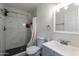Bathroom featuring updated fixtures, a mirror, a sink, toilet, and a black tiled shower at 3802 W Mission Ln, Phoenix, AZ 85051