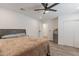 A relaxing bedroom with wood-look flooring, ample space, and a convenient mini fridge for added comfort at 3802 W Mission Ln, Phoenix, AZ 85051