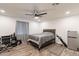 Bedroom features ceiling fan, modern wood flooring, mini fridge, and ample natural light at 3802 W Mission Ln, Phoenix, AZ 85051