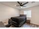 Bedroom features a ceiling fan, modern wood flooring, a window, and ample natural light at 3802 W Mission Ln, Phoenix, AZ 85051