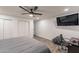 A bedroom featuring modern ceiling fan, closet doors, and gray scale design at 3802 W Mission Ln, Phoenix, AZ 85051