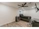 Bedroom features a ceiling fan, modern wood flooring, and mini fridge at 3802 W Mission Ln, Phoenix, AZ 85051