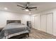 Bedroom features closet, ceiling fan, and wood flooring at 3802 W Mission Ln, Phoenix, AZ 85051