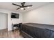 Bedroom with a ceiling fan, sleek desk, and modern wood flooring at 3802 W Mission Ln, Phoenix, AZ 85051