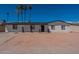Charming single-story home featuring a fresh white brick exterior and a well-maintained front yard with mature palm trees at 3802 W Mission Ln, Phoenix, AZ 85051