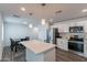 Bright kitchen features stainless appliances, white cabinetry, and a large center island connects to dining space at 3802 W Mission Ln, Phoenix, AZ 85051